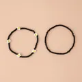 Ensemble de deux bracelets en perles noires avec breloques trèfle blanc de style bohème - Ensemble 2 pièces marguerite noire