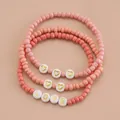 Lot de trois bracelets bohèmes en dégradé de rose avec lettres LOVE et breloques cœur - Ensemble 3 pièces LOVE