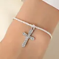 Silver woven rope bracelet featuring a shimmering cross pendant with crystal rhinestones - Bracelet / Silver