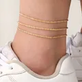 Gelaagde gouden enkelband met levensboom-schakels en getextureerde metalen ketting - 3 Stuks Gouden Enkelbandjes