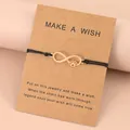 Infinity-poot vriendschapsarmband met zwart touw en een wenskaart cadeauverpakking - Goud