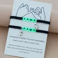 Black woven couple bracelets with dinosaur charms and glowing 'RAWR' letter beads - Luminous Dinosaur Black Rope