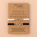 Pair of black and white woven bracelets with silver heart charms on a wish card - Pinky Promise Heart Black White Rope