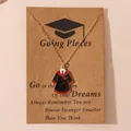 Golden graduation gown pendant necklace with enamel details on a kraft message card - Academic Gown Style 3