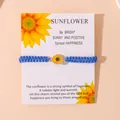Handgemaakte blauwe gevlochten zonnebloem armband op een inspirerende witte cadeaukaart - Blauw