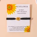 Handmade black braided cord bracelet featuring a yellow enamel sunflower charm on a card - Black
