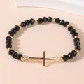 Kruis kralenarmband met zwarte facet geslepen kristallen en gouden edelstalen bedels - Zwart