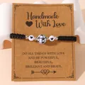 Handmade black braided football charm bracelet with heart beads on a kraft card - Football