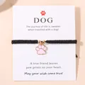Verstelbare zwarte geweven armband met roze emaille hondenpoot hanger en displaykaart - Roze