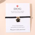 Bracelet cordon noir avec breloque patte de chien émaillée or sur carte cadeau - Noir