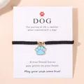 Bracelet tressé noir réglable avec pendentif patte de chien bleu clair sur carte - Bleu