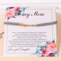 Bracelet MAMA tressé gris fait main avec lettres dorées sur carte florale - Gris - Étiquette Dorée