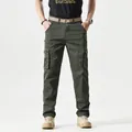 Detail of army green cargo pants featuring large side pockets with snap button closure - Army Green / 38