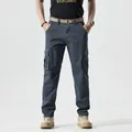 Detail of men's dark blue cargo pants with side pockets and a woven brown belt - Dark Gray / 38