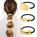 Detailed view of three gold geometric hair ties on a ponytail with metallic texture - Gold Geometric Irregular Style Combo