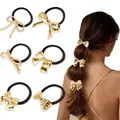 Detail of six golden bow elastic hair ties with smooth and pleated metal finishes - Gold Multiple Bow Styles Combo
