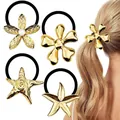 Detail of gold floral and starfish hair ties with high elasticity black rubber bands - Gold Pearl Ocean Theme Combo