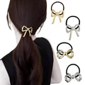 Close-up of gold and silver metallic bow hair ties featuring elegant hollowed designs - Gold Silver 3D Bow Combo