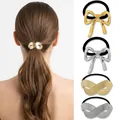 Detailed view of elastic hair tie with gold and silver infinity and bow metal charms - Shiny Matte Gold Silver Infinity Bow Combo
