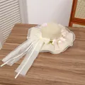 Elegant wide-brim straw sun hat in beige featuring white organza bow and floral accents - Wrapping Lily of the Valley Beige