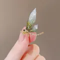 Elegant gold-tone dragonfly brooch featuring emerald green wings and sparkling rhinestones - Green Dragonfly