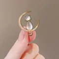 Elegant gold crescent moon brooch with opal cat detail and sparkling cubic zirconia stones - Moon and Cat