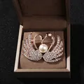 Elegant rose gold twin swan brooch with white crystals and pearl in a gift box - Twin Swans