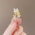 Elegant gold leaf brooch with yellow and champagne marquise-cut zircon stones - Rice Flower