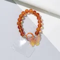 Detail of orange beaded phone charm with iridescent butterfly pendant and lobster clasp - Orange