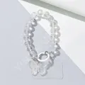 Detail view of crystal beaded phone chain with iridescent butterfly pendant and white clasp - White