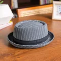Detailed view of grey pinstripe vintage pork pie hat on a cozy wooden table background - 58cm / Gray