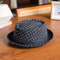 Detail of British style black pork pie hat with white diamond pattern and satin ribbon - 58cm / Black Grid