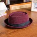 Close-up of burgundy plaid dome hat with black grosgrain band on a wooden desk - 58cm / Plaid Wine Red