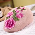 Light pink knitted beret featuring exquisite rose floral embroidery in a side view - Rose Embroidery / Pink