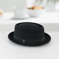 Classic black wool pork pie hat with decorative grosgrain ribbon and silver metal emblem - 60CM / Black