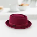 Classic burgundy wool pork pie hat with ribbon and metal logo on a white desk - 60CM / Burgundy
