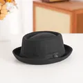 Classic black wool pork pie hat with vintage rolled brim and circular metal emblem accent - 58cm / Crown Style / Black