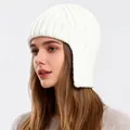 Close-up detail of white chunky knit earflap hat showing the thick wool texture and stitching - White