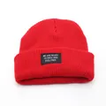 Red knit beanie with black woven patch featuring white typography lettering - Adjustable / Red