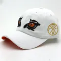 White cotton baseball cap with cartoon eye embroidery and side gold badge detail - Adjustable / White