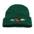 Close-up of three colorful embroidered dinosaurs on a dark green knit beanie - Adjustable / Green