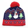 Detail of navy blue Christmas knit hat with snowman patterns and red fluffy pompom top - Snowman Christmas Tree Style