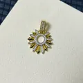 Macro detail of sun flower pendant with sparkling cubic zirconia and golden finish - Sunflower Shaped Zirconia Style