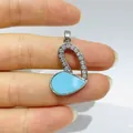 Macro detail of heart pendant with sky blue stone and micro-pave crystals in silver finish - Blue Stone Micro-set Splice Heart Style (Silver 4)
