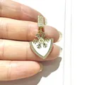 Detailed view of gold shield pendant with white enamel snowflake and zircon accents - Gold White Shield Snowflake (2)