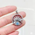 Macro shot of silver Turkish Evil Eye pendant with micro-pave cubic zirconia crystals - Silver Round Radial Evil Eye (#4)