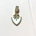 Detailed macro view of gold clover shield pendant with white enamel and pavé zircons - Gold White Shield Clover (4)