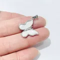 Macro detail of butterfly pendant with mother of pearl inlay and sparkling zircons - White No. 2