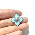 Silver four-petal flower pendant with light blue enamel and zircon, held in hand - Four-Petal Flower Shape (White K No.1) / Silver
