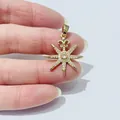Elegant gold-plated star pendant with zircon stones held by hand to show medium size - Octagram Star Style